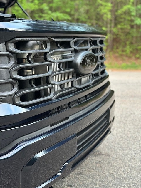 F150 twin turbo kit installed with intercooler visible through grille